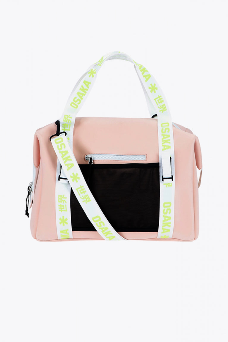 Osaka neoprene duffel bag in powder pink with logo in white on the bag and in green on the straps. Back view