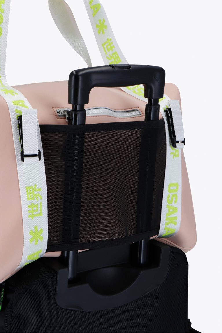  Osaka neoprene duffel bag in powder pink with logo in white on the bag and in green on the straps. Detail back view