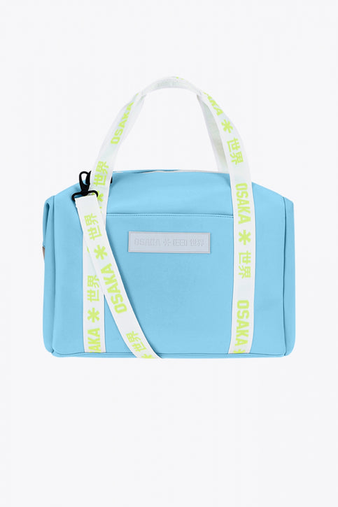 Osaka neoprene duffel bag in light blue with logo in white on the bag and in green on the straps. Front view