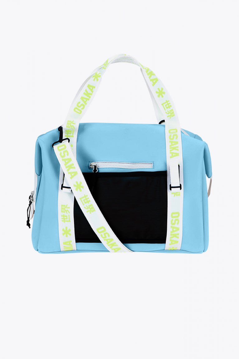 Osaka neoprene duffel bag in light blue with logo in white on the bag and in green on the straps. Back view
