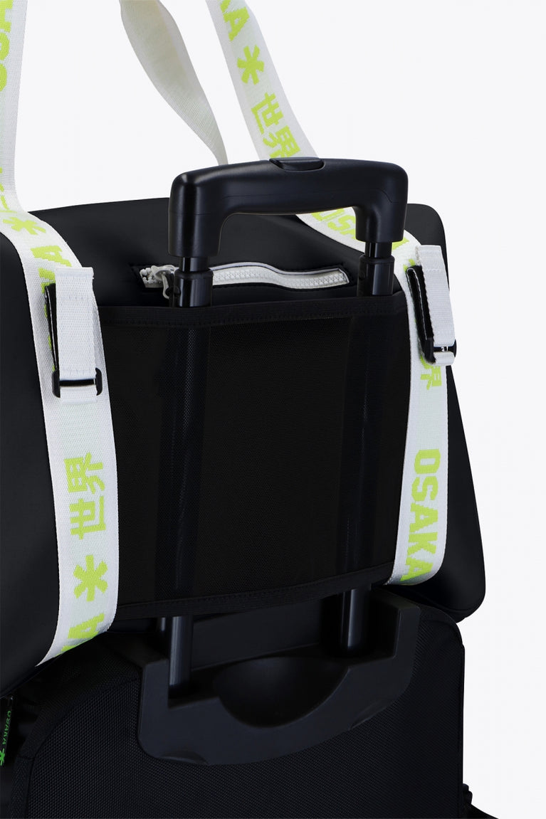 Osaka neoprene duffel bag in black with logo in white on the bag and in green on the straps. Detail back view