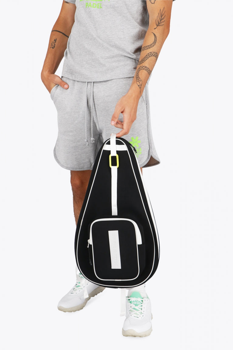 Osaka neoprene padel bag in black with logo in white. Man holding the bag