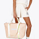Osaka neoprene Tote bag in powder pink with logo in white. Woman holding the bag