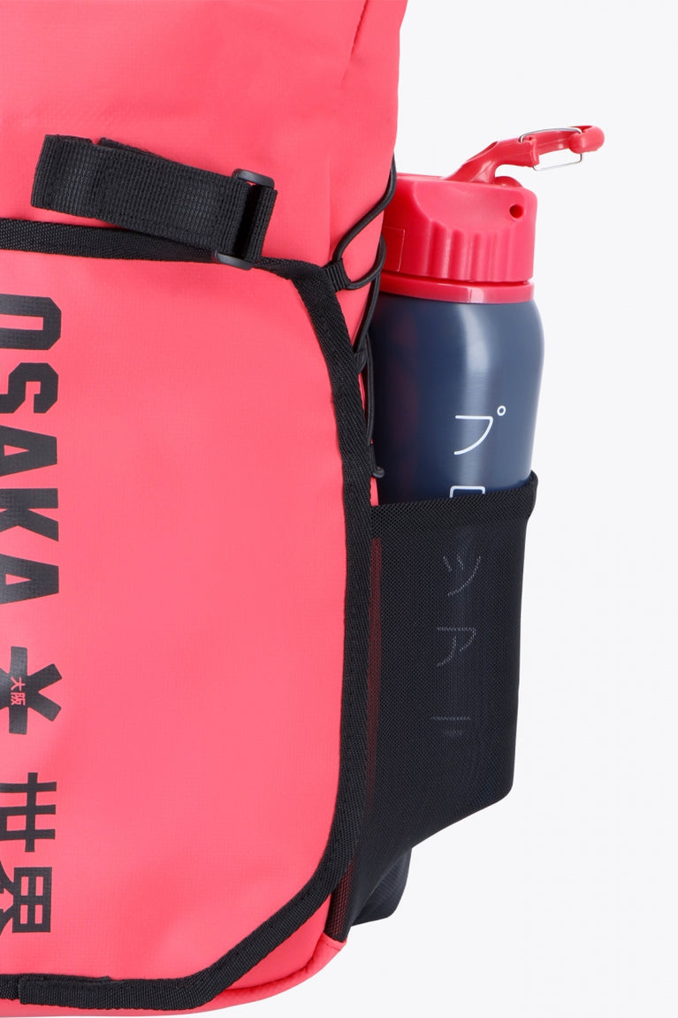 Osaka Pro Tour backpack in red with logo in black. Water bottle holder view