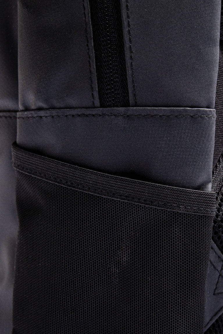 Osaka x Nexus backpack medium in black with white Osaka and Nexus logo on it. Detail water bottle holder view