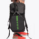 Osaka vision padel backpack in black with logo in green. Woman holding the bag