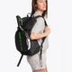 Osaka vision padel backpack in black with logo in green. Woman wearing the bag back view