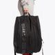 Pro Tour padel bag in black with logo in black. Woman holding the bag