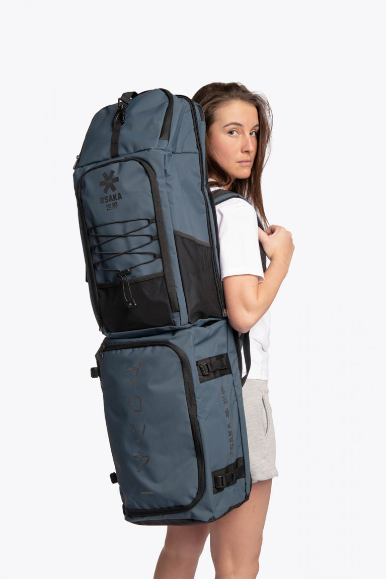 Osaka Hockey Stickbag Pro Tour extra large in navy with logo in black. Woman wearing the bag