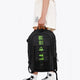 Osaka Pro Tour backpack in black with logo in green. Woman holding the bag