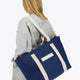 Osaka neoprene Tote bag in navy with structure and logo in white. Woman wearing the bag