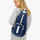Osaka neoprene padel bag in navy with structure and logo in white. Woman wearing the bag