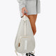Osaka neoprene padel bag in light grey with structure and logo in white. Woman holding the bag