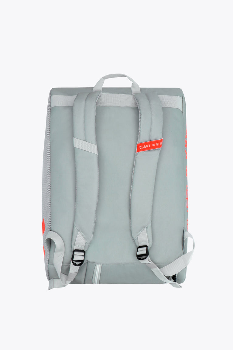 Osaka sports padel bag medium in grey with logo in orange. Side view with straps