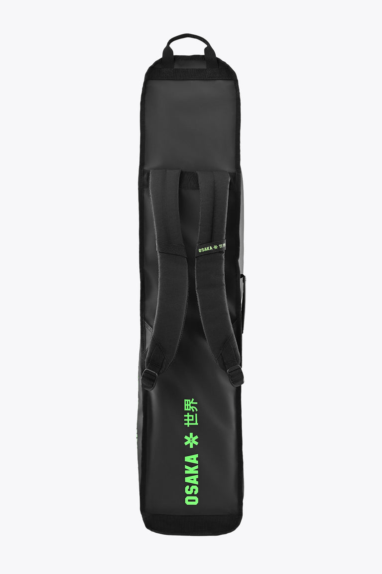 Medium stickbag in black with top handle, front pocket, and green Osaka logo