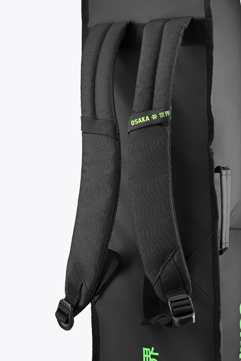 Medium stickbag black with padded backpack straps and green Osaka label