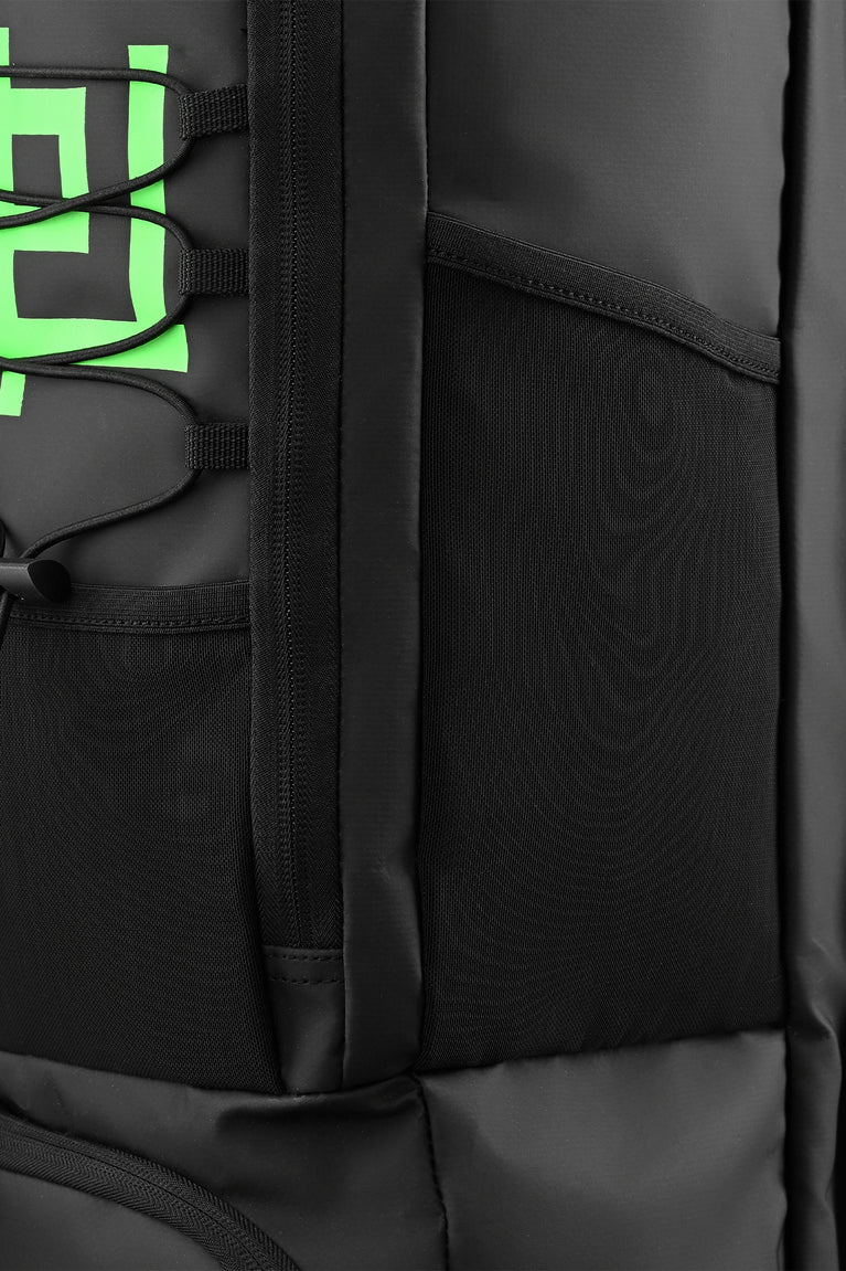 Medium stickbag black with textured panels and zipper seams; green graphic detail