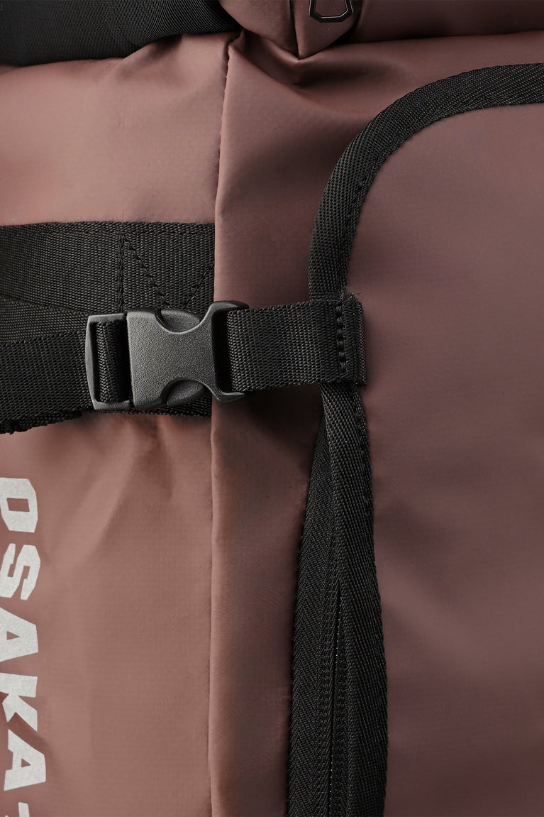 Large Osaka stick bag close-up of black adjustable strap and plastic buckle hardware.