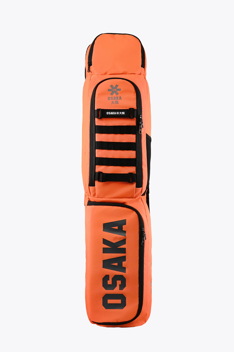 Medium orange stickbag with black trim, front ladder straps and zip pocket.