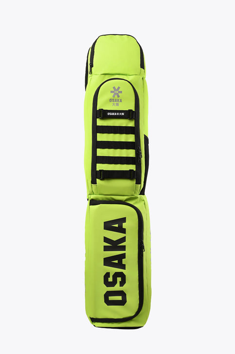 Lime green stickbag with black trim, zip pocket, and Osaka logo stripes