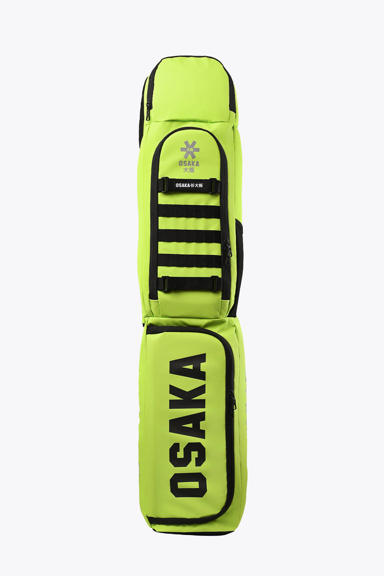 Lime green stickbag with black trim, zip pocket, and Osaka logo stripes