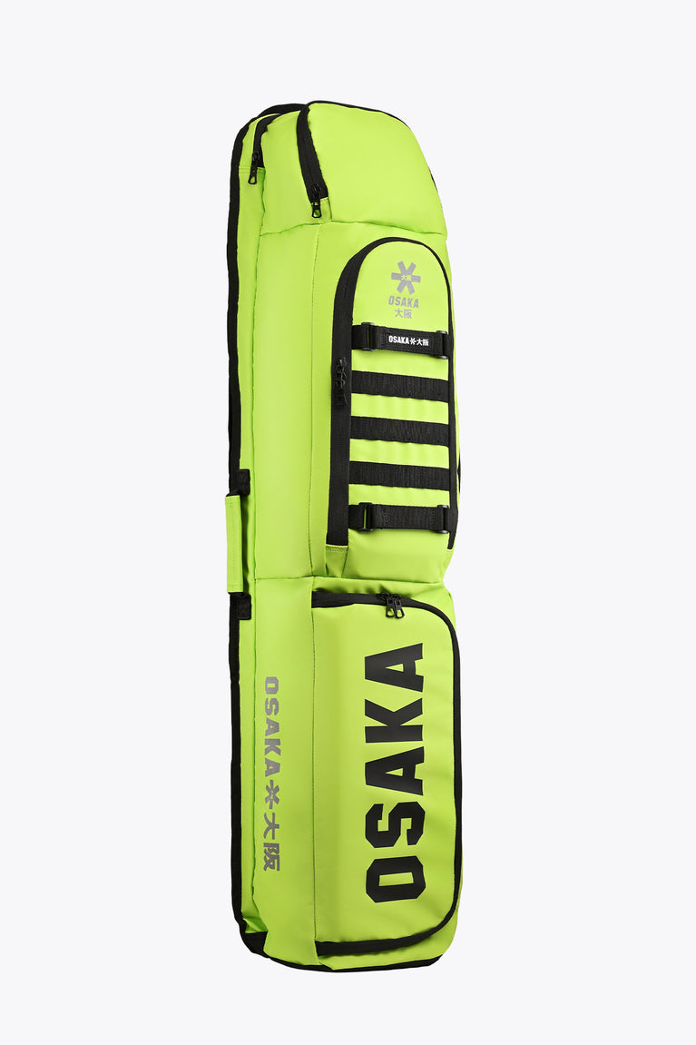 Lime green stickbag with black trim, front zip pocket, and Osaka logo panel