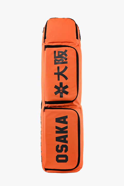 Orange stick sports stickbag with black trim and two front padded compartments