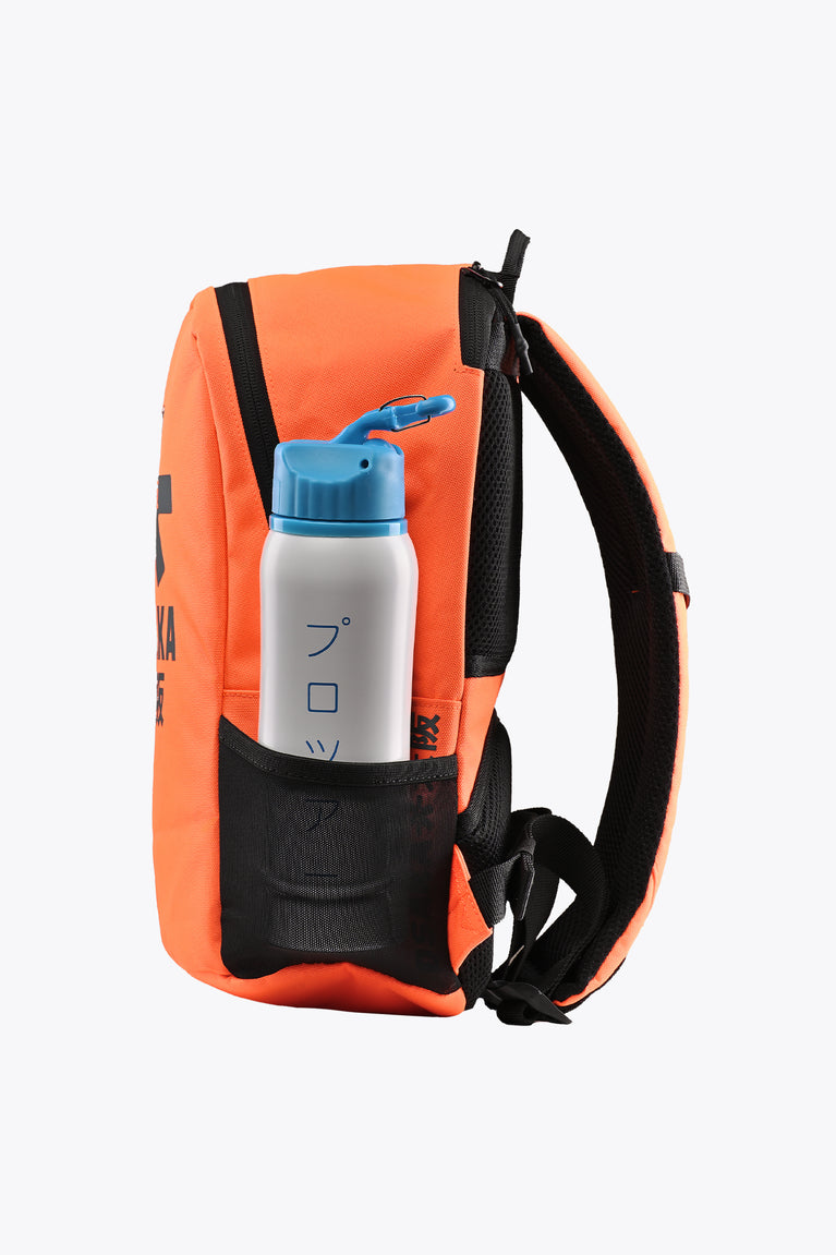 Kids sports backpack with side bottle pocket holding a blue drink bottle