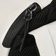 Close-up of backpack zipper and black mesh pocket detail on white fabric