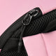 Close-up of pastel pink backpack zipper with black mesh trim