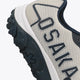 Osaka footwear Kai Mk1 in grey navy with logo in navy. Detail logo view