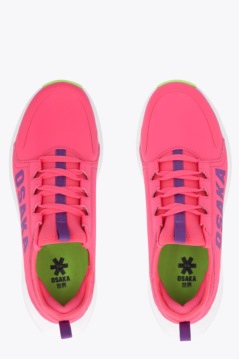 Hot pink kids sneakers with lace-up front, purple eyelets, and green OSAKA lining.