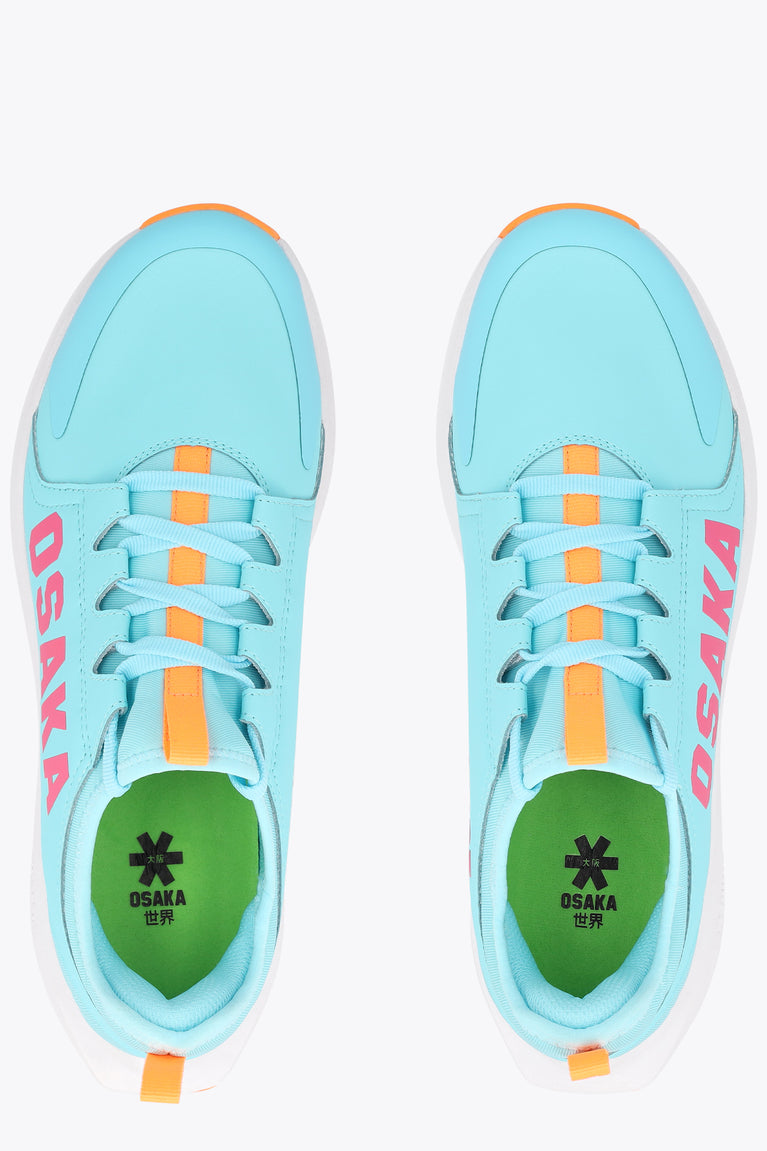 Light blue sneaker with orange lace accents and OSAKA branding at the insole
