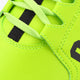 Neon lime lace-up sneaker close-up with black lace blocks and stitching
