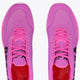 Rose bud pink low-top sneakers with neon green sole and pink lace-up front