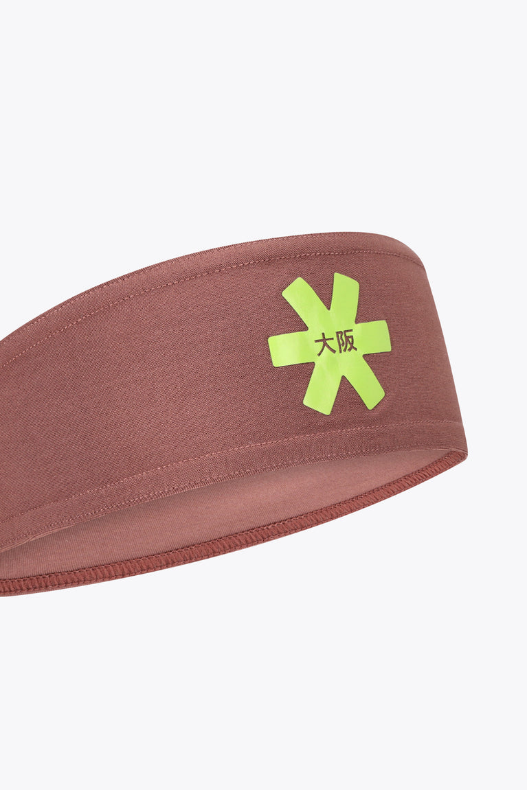 Sports bandana close-up with neon green logo patch on peppercorn brown fabric