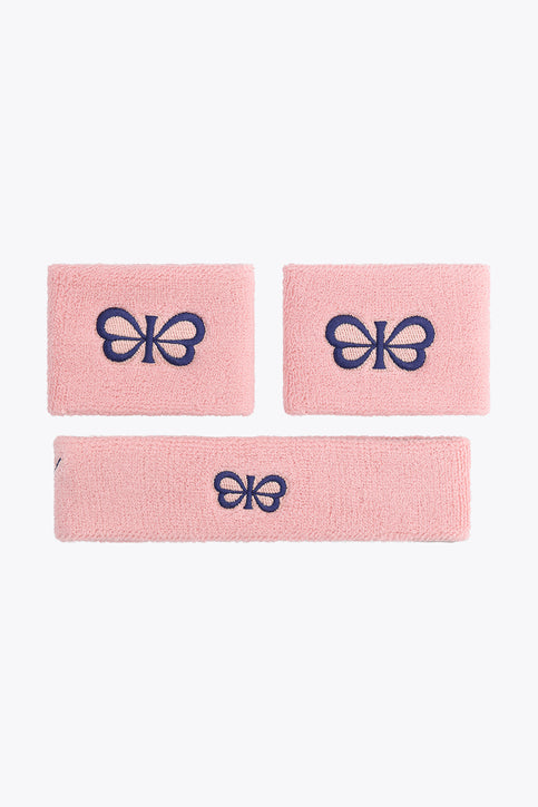 Pastel pink sweatband set, three woven wristbands with dark blue emblem logo.