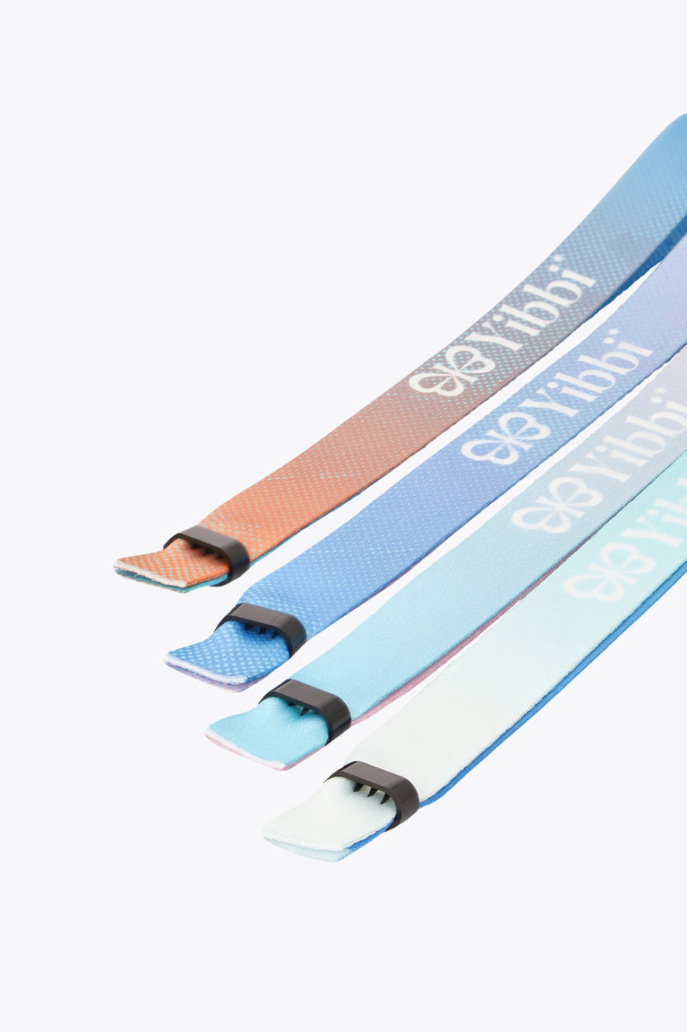 Three multicolor Yibbi fabric bracelets with elastic ends, angled close-up