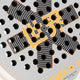 Osaka vision pro padel racket in white and orange with logo in black. Detail logo view