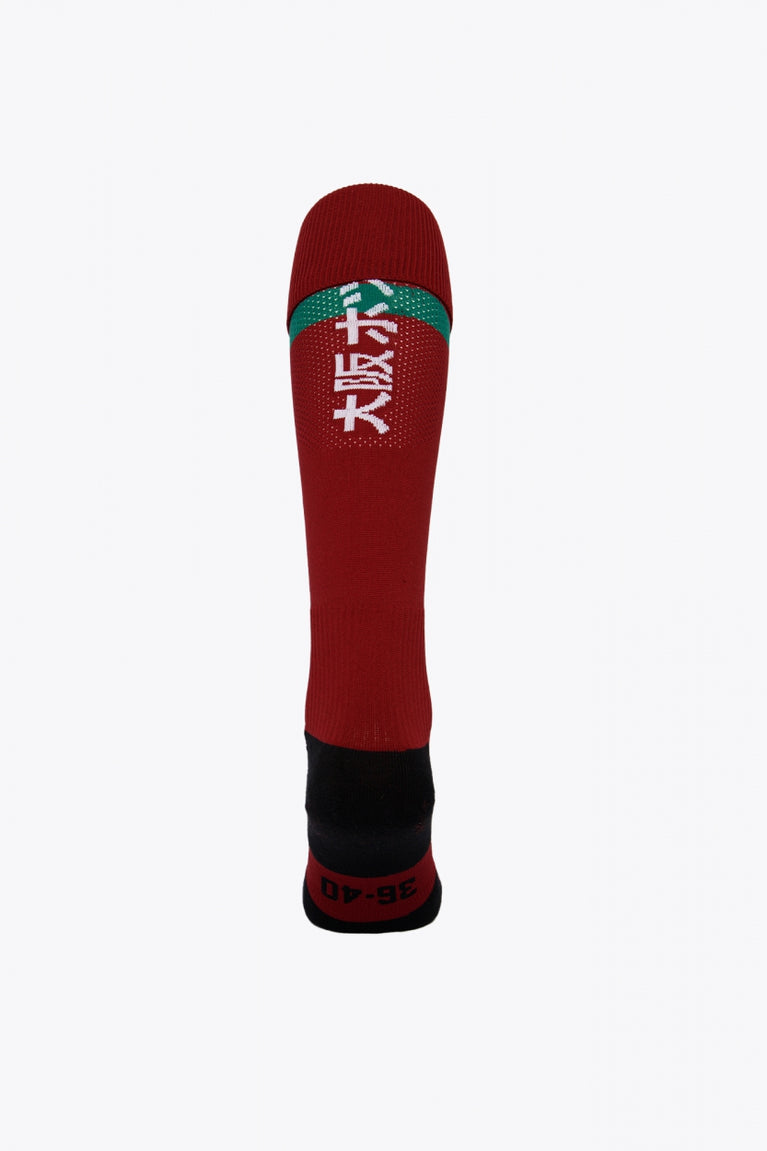 Castelldefels Field Hockey Socks in red with Osaka logo in green. Back view