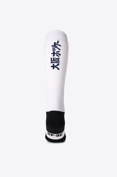 Herakles Field Hockey Socks in white with Osaka logo in green. Front view