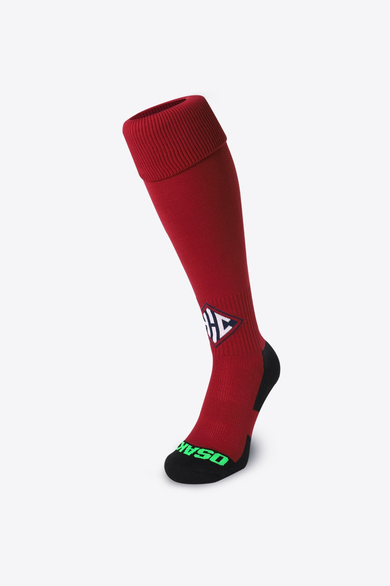 Herakles Field Hockey Socks in bordeaux with Osaka logo in green. Front view