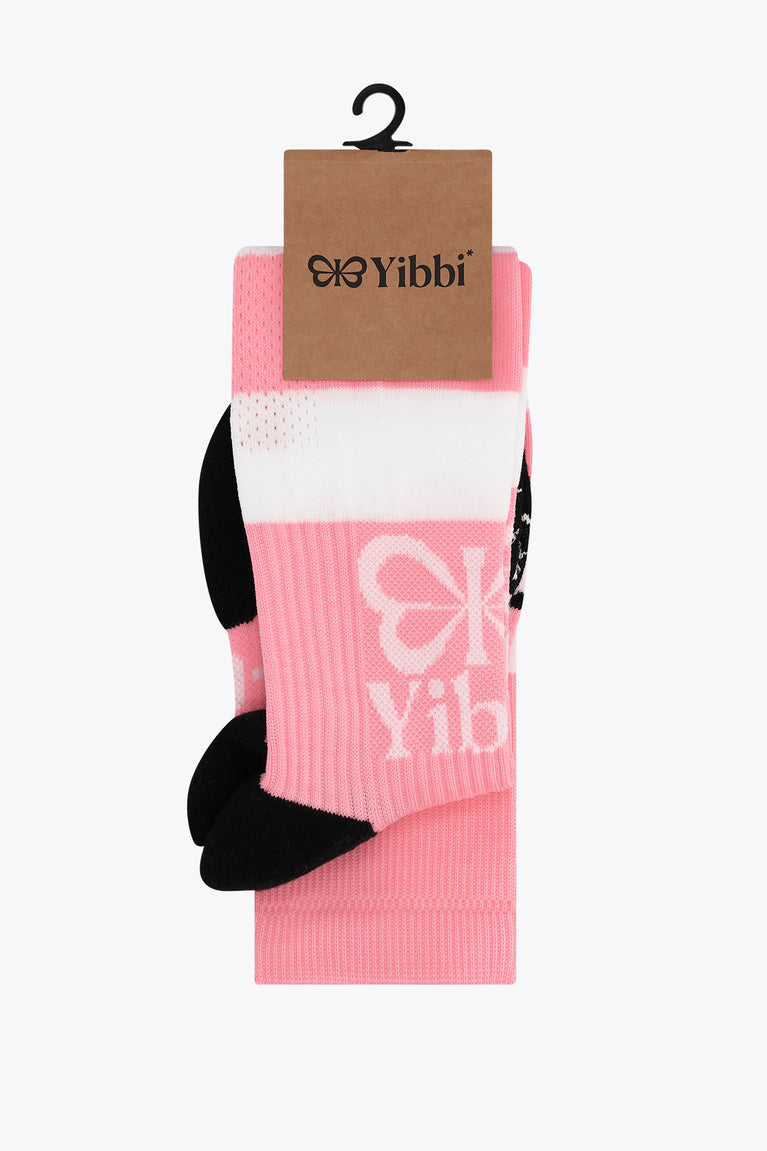 Pastel pink field hockey socks with Yibbi brand tag and pink white stripes