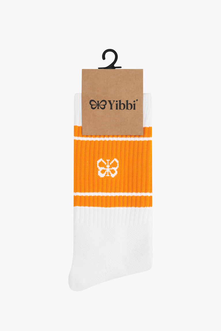 Orange and white sport socks on tag with Yibbi logo and flower emblem