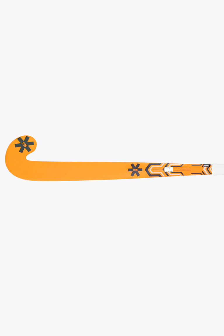 Orange indoor hockey stick lying flat, showing full mid-bow shape and graphics