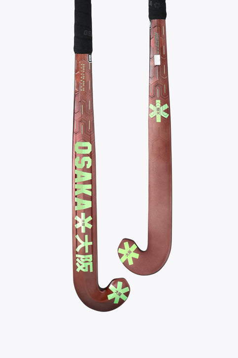 Pair of brown field hockey sticks with green decals and black grips.