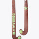 Pair of brown field hockey sticks with green decals and black grips.