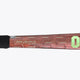 Brown field hockey stick shaft with geometric pattern and green '0' marking near grip.