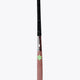 Field hockey stick top-to-blade view showing dark brown head and lime star decals.