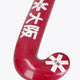 Hot pink curved field hockey blade with printed star logos and textured surface